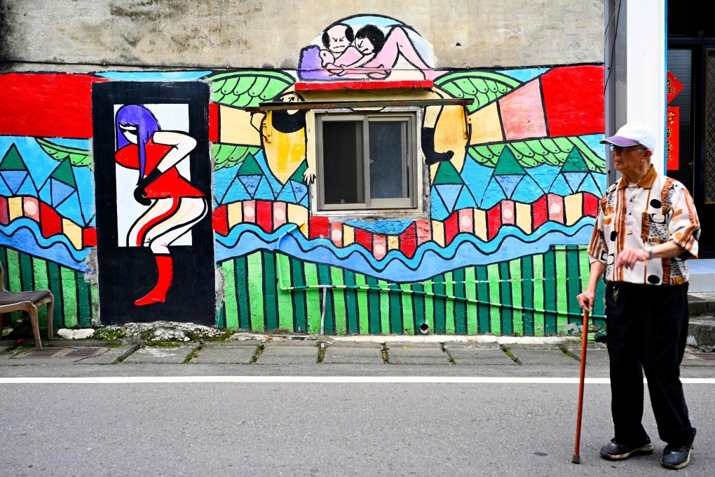 A man walks past a mural in Ruan Chiao. Photo: AFP
