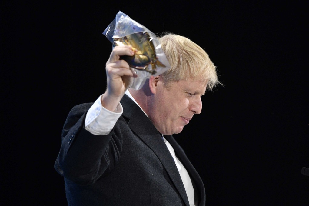 Boris Johnson holding a kipper at a Conservative Party leadership campaign hustings in London on Wednesday. Photo: EPA