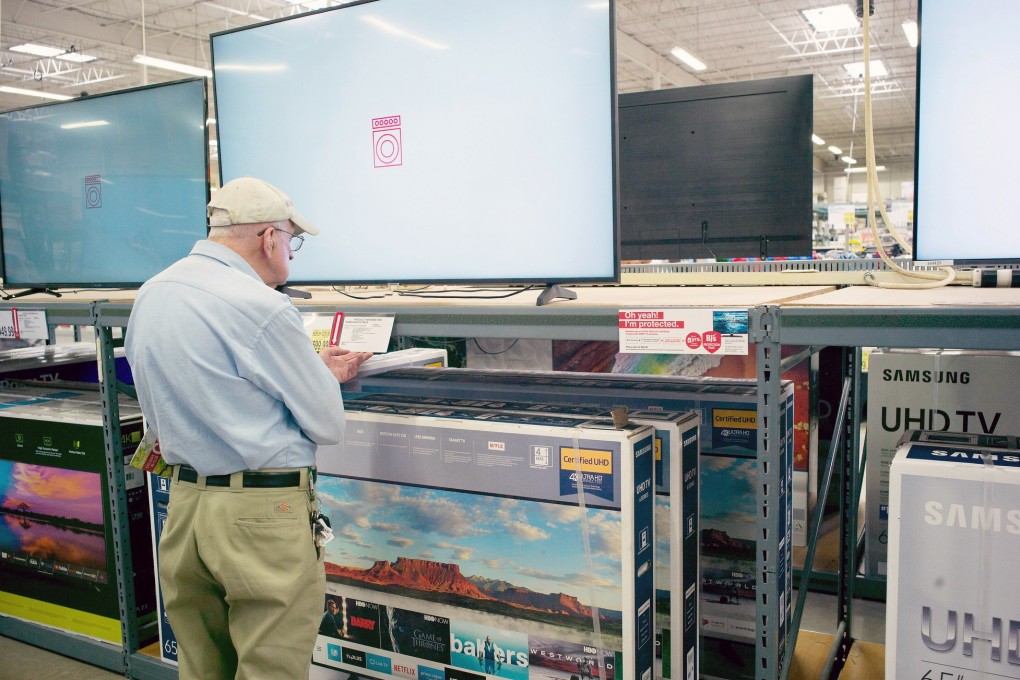 A customer looks over televisions on display at a BJ's Wholesale Club store in Stoneham, Massachusetts, USA, 16 May 2019. EPA-EFE/CJ GUNTHER