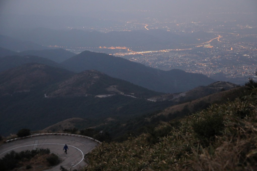 A hiker climbs Tai Mo Shan early in the morning. The long winding road is a good place for hill running training, but not advisable for beginnings. Sam Tsang