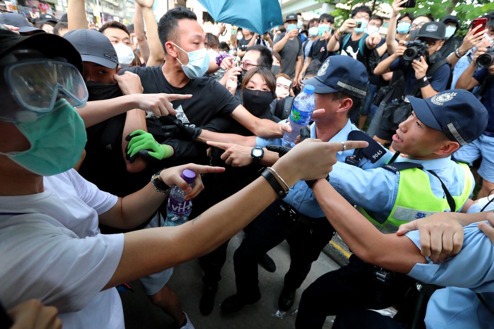Protesters clash with police after a march against parallel trading by mainland Chinese visitors in Sheung Shui on July 13. Photo: Felix Wong
