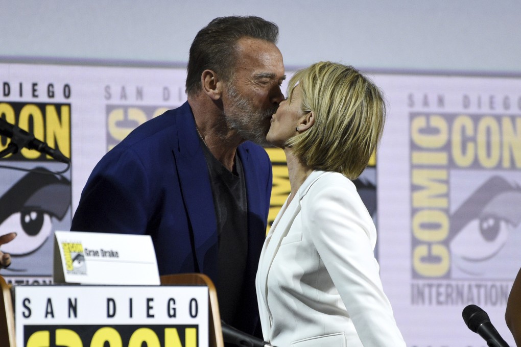 Arnold Schwarzenegger and Linda Hamilton kiss at Comic-Con, where they took part in a discussion about Terminator: Dark Fate, the latest film in the Terminator franchise. Hamilton, last seen in Terminator 2, is reprising her role as Sarah Connor. Photo: Chris Pizzello/Invision/AP