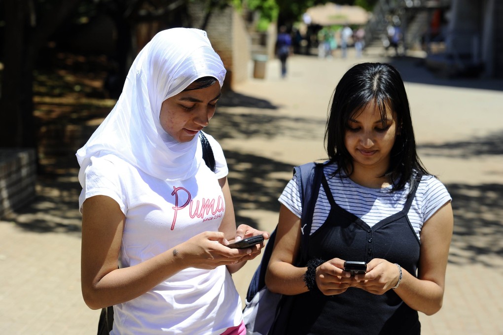 Students use their mobile phones at the Witwatersrand University in Johannesburg, South Africa. In the first quarter of this year Africa’s smartphone shipments declined 7.1 per cent quarter on quarter to 21.5 million units. Photo: AFP