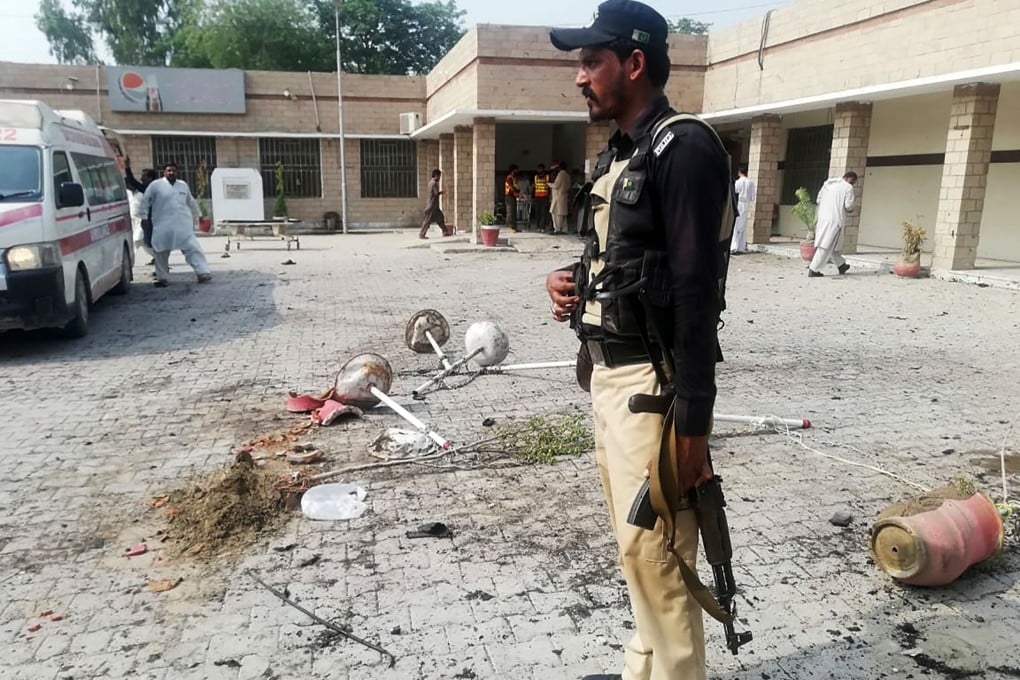 A Pakistani policeman stands guard at the site of the blast. Photo: AFP