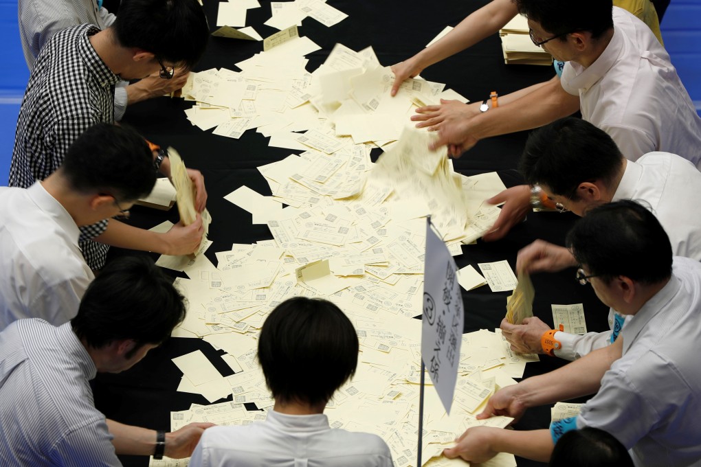 Election officers count votes at a ballot counting centre in Tokyo. Photo: Reuters