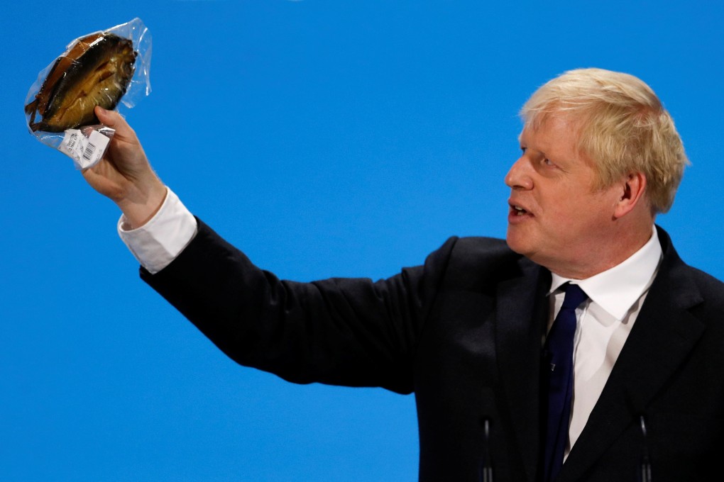 Boris Johnson, a leadership candidate for Britain's Conservative Party, holds a plastic wrapped kipper fish during a hustings event in London. Photo: Reuters