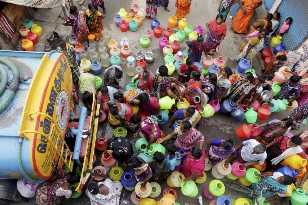 Indians stand in queues to collect drinking water from a tanker in Chennai. Photo: AP