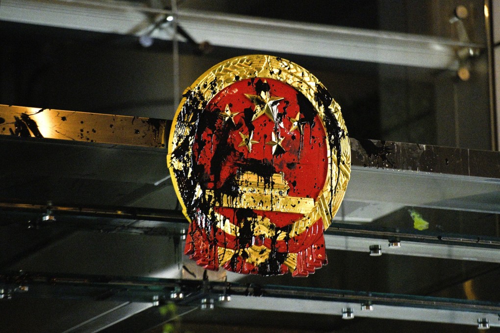 The defaced national emblem at Beijing’s liaison office in Sai Ying Pun after some protesters temporarily lay siege to it following a mass rally on July 21. Photo: Kyodo