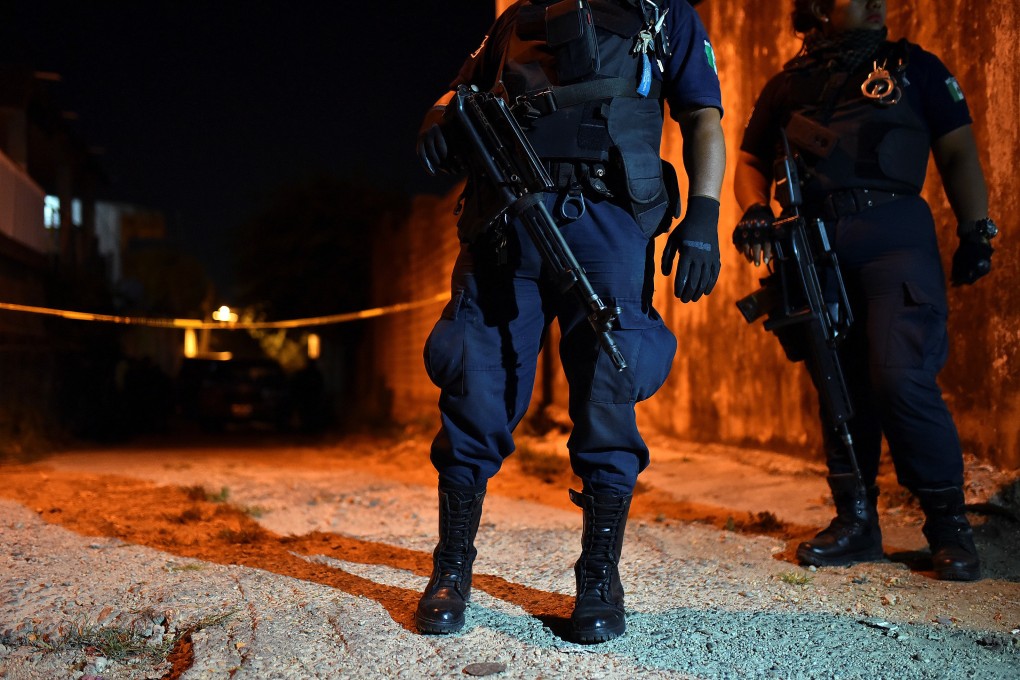 Policemen guard a crime scene in Minatitlan, Veracruz in April. Photo: Reuters