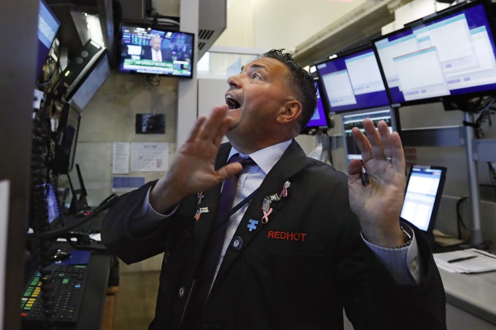 A trader on the floor of the New York Stock Exchange. The Fed and other central banks are considering interest rate cuts and loosening other policy measures, which could extend the current cycle, according to Investec. Photo: AP