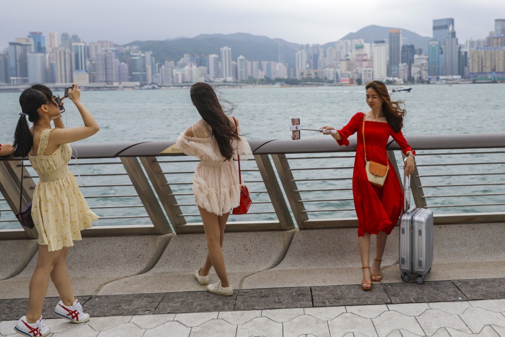 Tourists take pose for photos at the Avenue of Stars in Tsim Sha Tsui. Photo: Sam Tsang