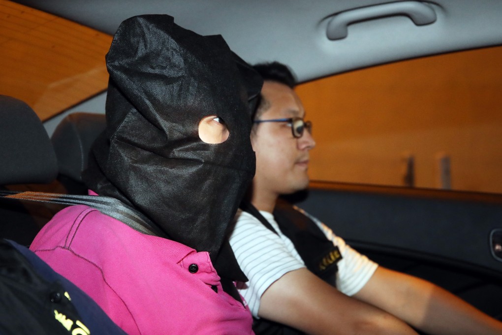 A suspect arrested in connection with the Yuen Long violence on Sunday night is escorted to Tin Shui Wai police station. Photo: Winson Wong