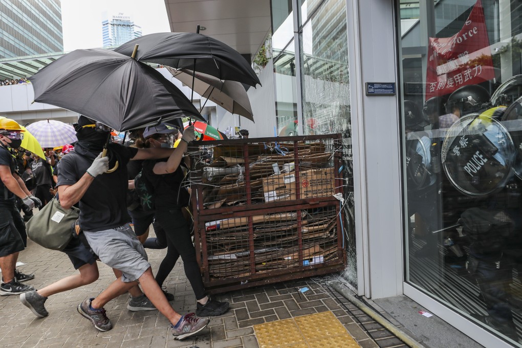 Protesters ram the windows of the Legislative Council Complex during a protest on July 1. Photo: Sam Tsang
