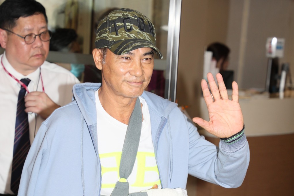 Hong Kong film star and stab victim Simon Yam waves to well-wishers on Wednesday as he leaves hospital. Photo: Handout