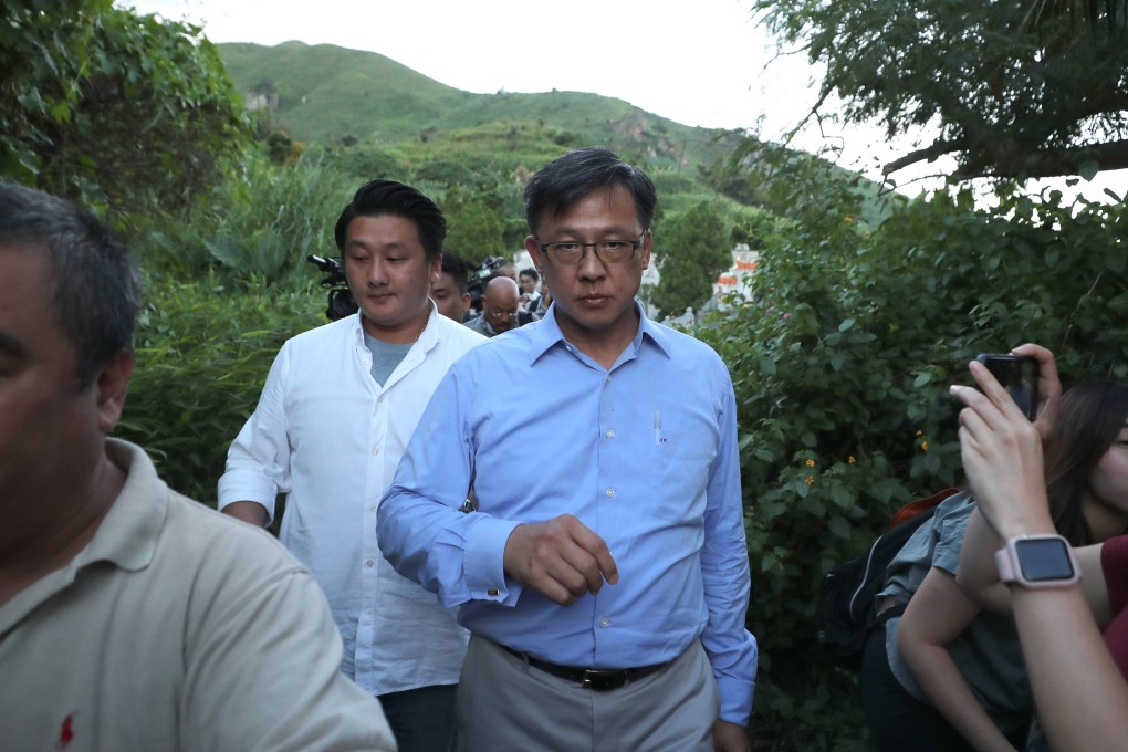Lawmaker Junius Ho Kwan-yiu (centre) arrives to see the damage to his parents' grave at the Castle Peak Christian Cemetery in Tuen Mun. Photo: Sam Tsang