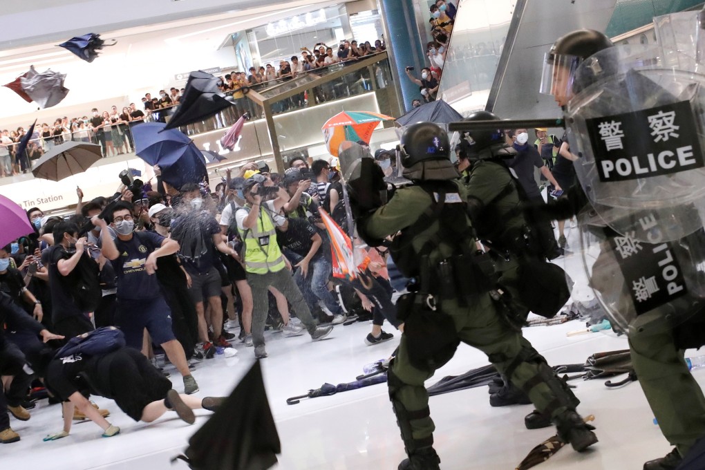 Riot police use pepper spray to disperse pro-democracy activists inside a mall after an anti-extradition march in Sha Tin, on July 14. The extradition bill controversy is not only affecting the lives of Hongkongers, it has also drawn intense international media attention. Photo: Reuters