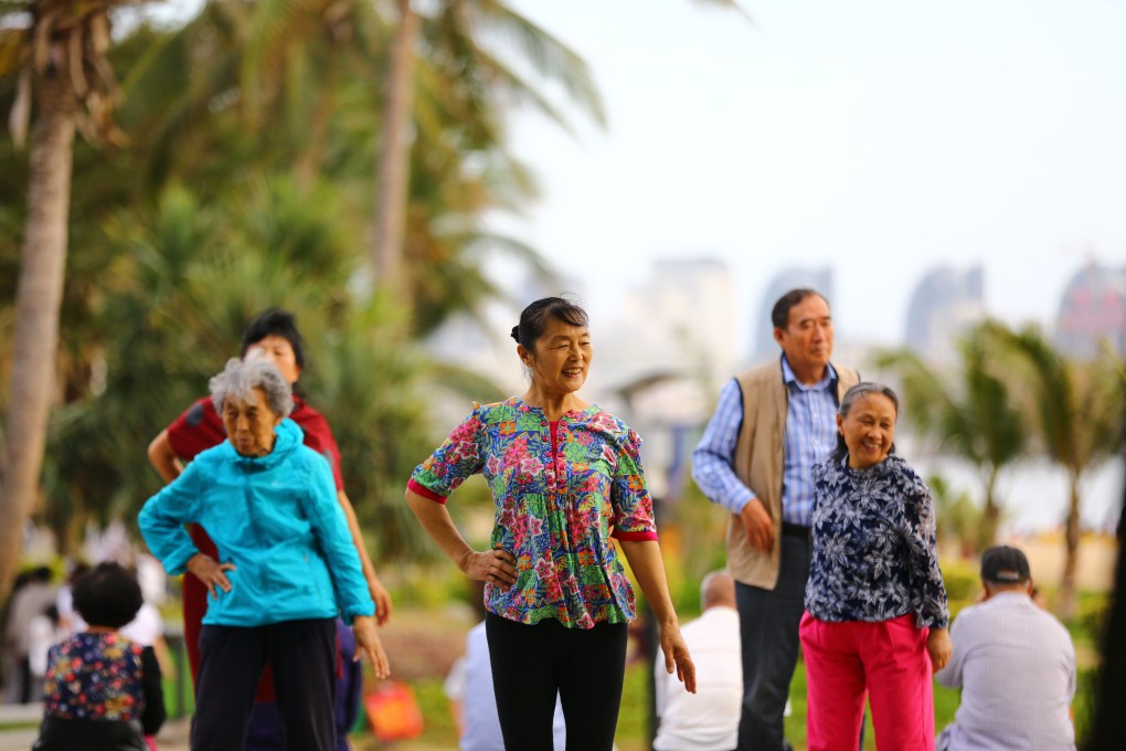 Elderly people walk along the beach in Sanya in China’s Hainan province in February 2017. The island province is fast becoming known as “China’s Florida”, drawing masses of retirees fleeing the biting cold of their hometowns. Photo: AFP