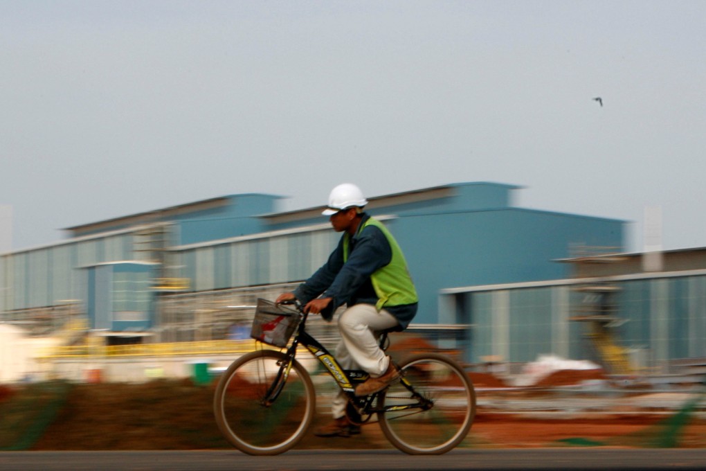 A worker cycles past the Lynas factory in Gebeng, east of Kuala Lumpur. Photo: Reuters