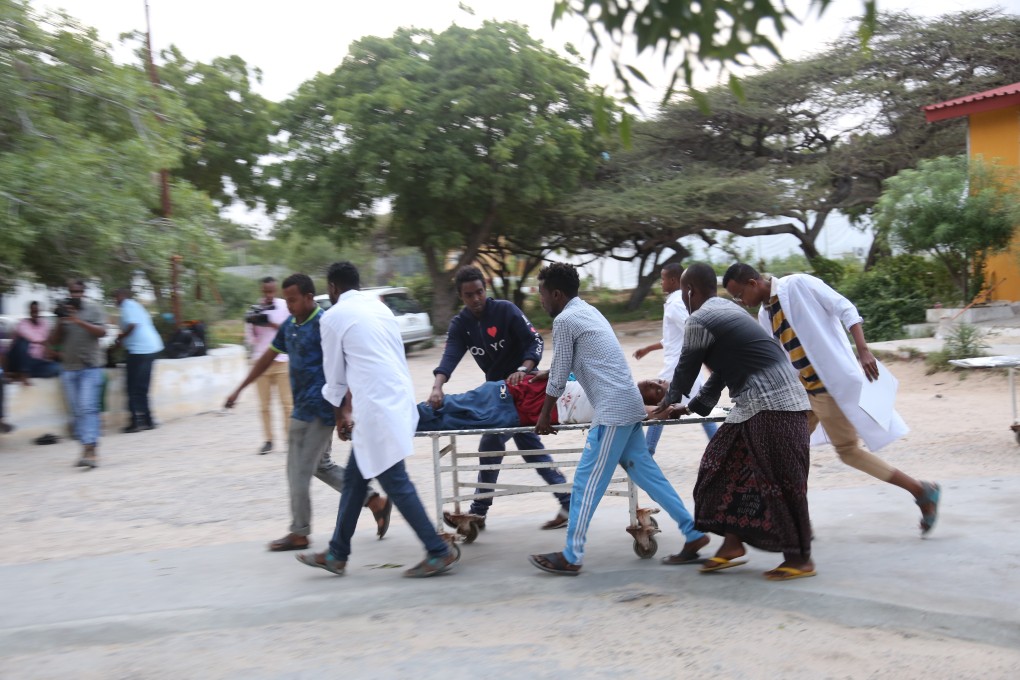A wounded person is carried on a stretcher after a suicide attack at Mogadishu mayor’s offices. Photo: Xinhua