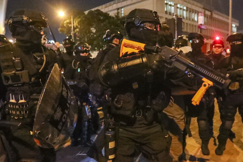 Riot police arrive in Sheung Wan to clear extradition bill protesters on July 21. Photo: Felix Wong