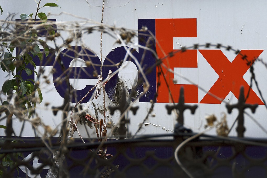 A FedEx service station is seen through barbwires in Yantai in east China's Shandong province, June 2019. Photo: AP.