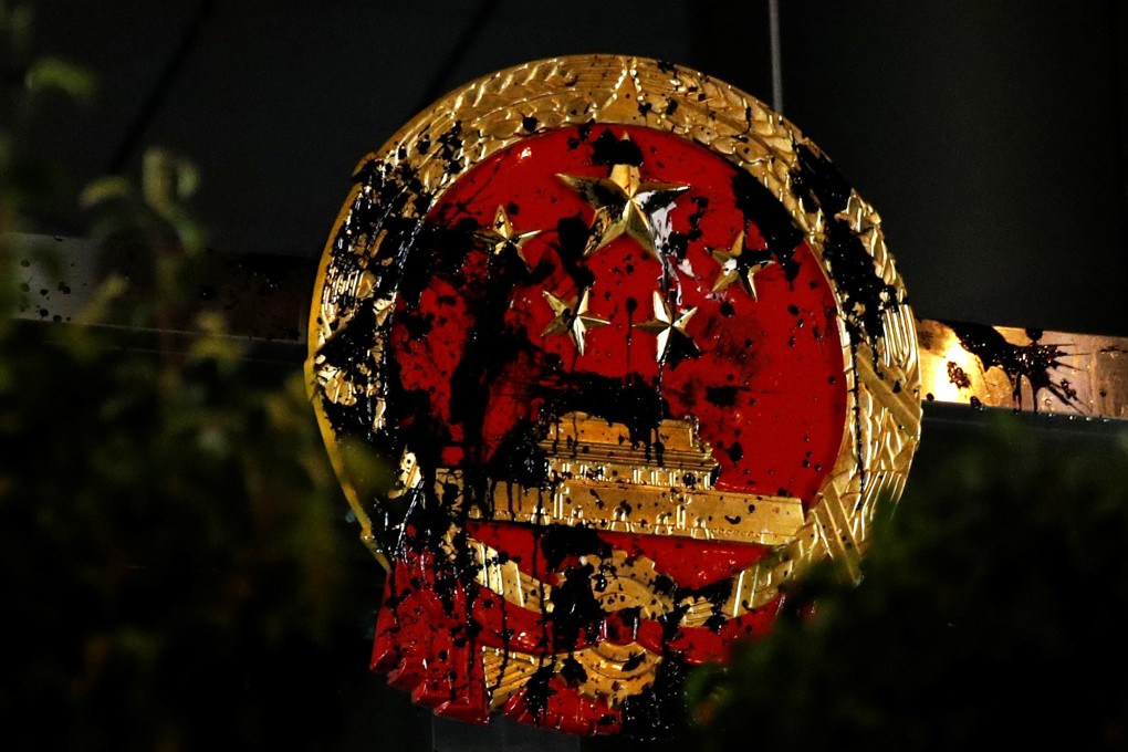 Vandalism of the Chinese national emblem at the central government’s liaison office in Hong Kong is a mistake. It makes it easier for Beijing to present mass protests in Hong Kong as a foreign plot. Photo: Reuters