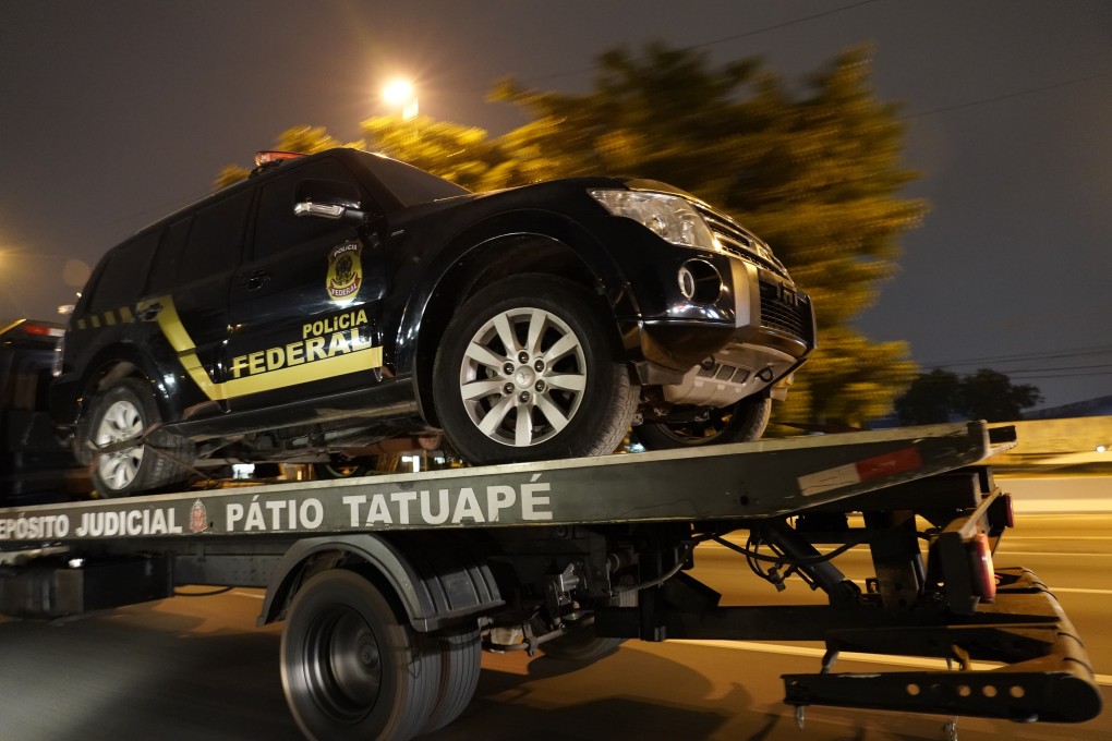 A fake police vehicle that was used in the robbery is transported on a flat-bed truck in Sao Paulo, Brazil. Photo: AP
