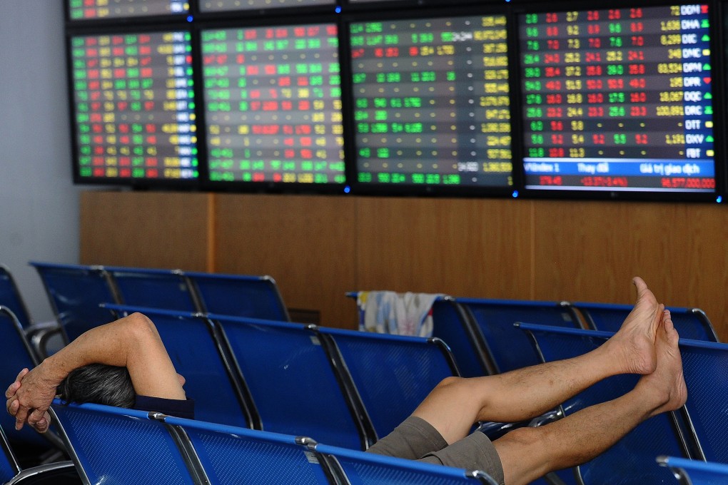 A Vietnamese investor watches share price activity on a securities trading floor in Hanoi. Photo: AFP