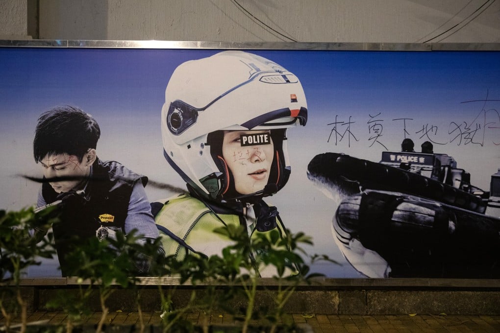 A poster defaced with anti-government and anti-police slogans at Western Police Station during a protest on July 21. Photo: Bloomberg