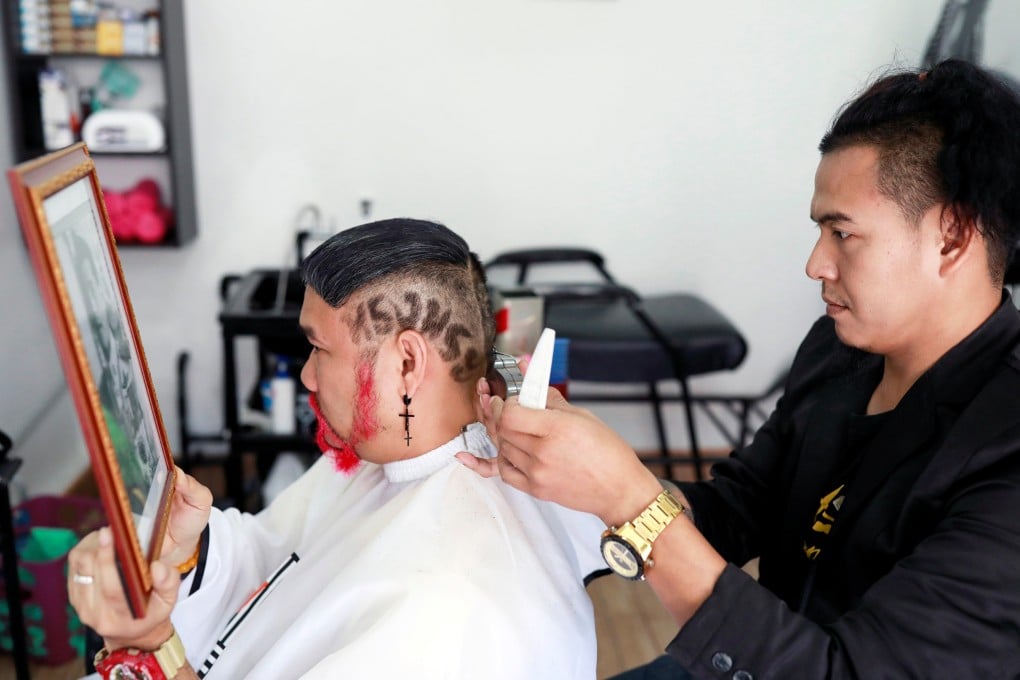Mitree Chitinunda gets a haircut to mark the Thai king’s 67th birthday. Photo: Reuters