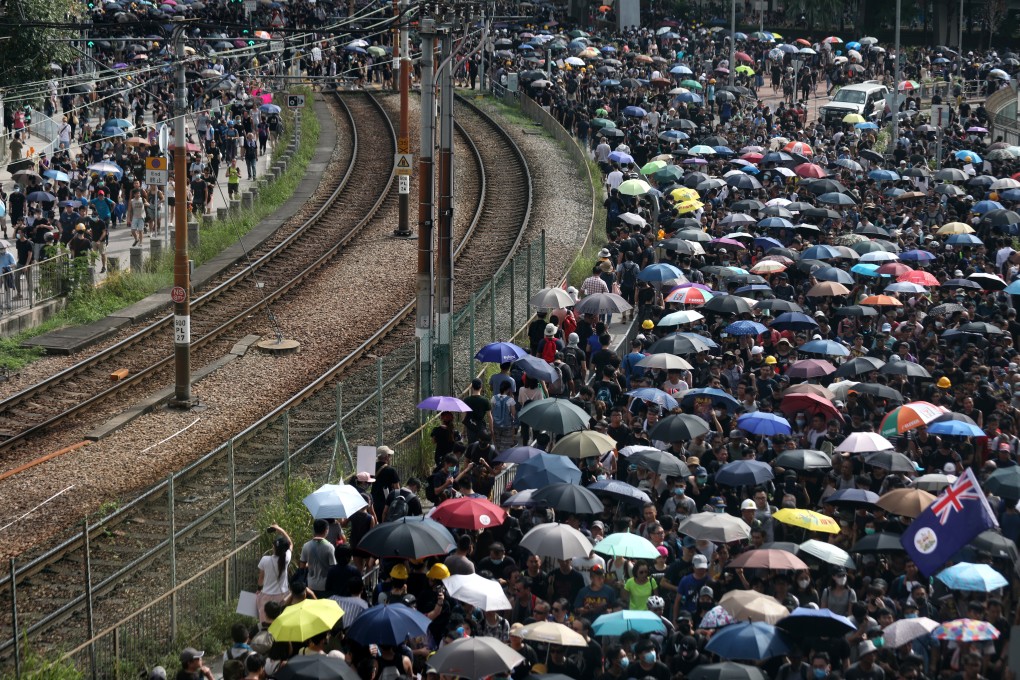 Protesters line the train tracks in Yuen Long during Saturday’s demonstration. Photo: Xiaomei Chen