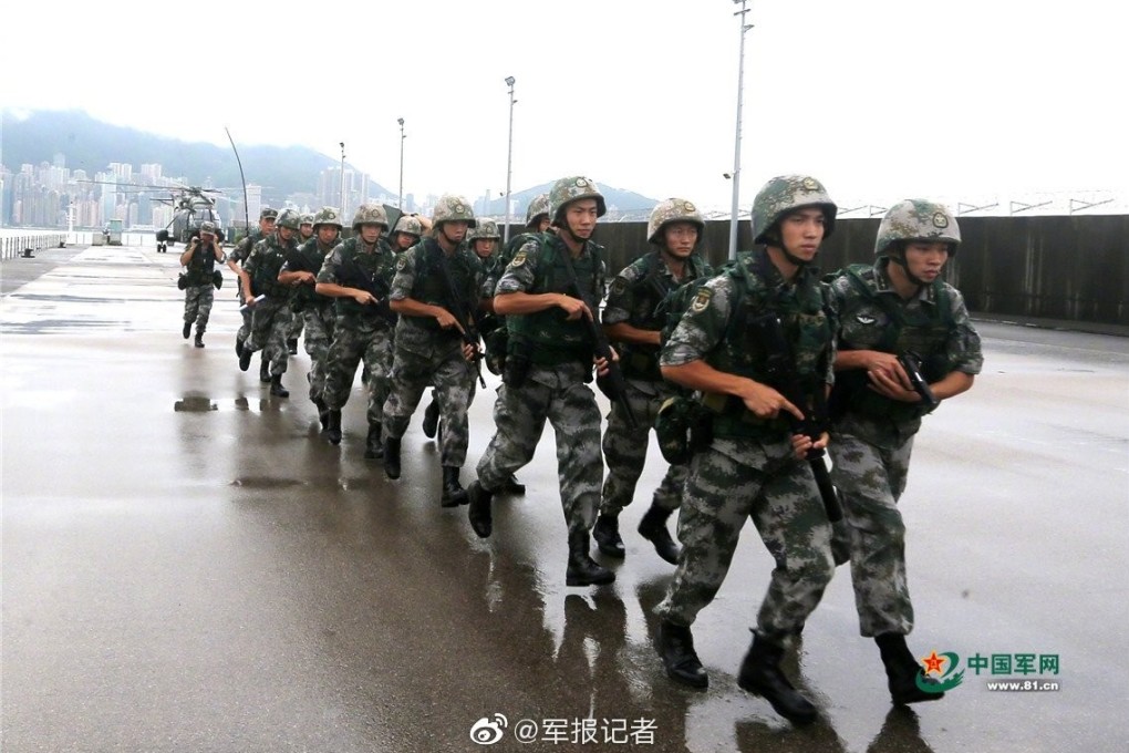 Troops from the People’s Liberation Army in an exercise alongside Victoria Harbour, on the 150m strip of Hong Kong land that became PLA property last month. Photo: Weibo