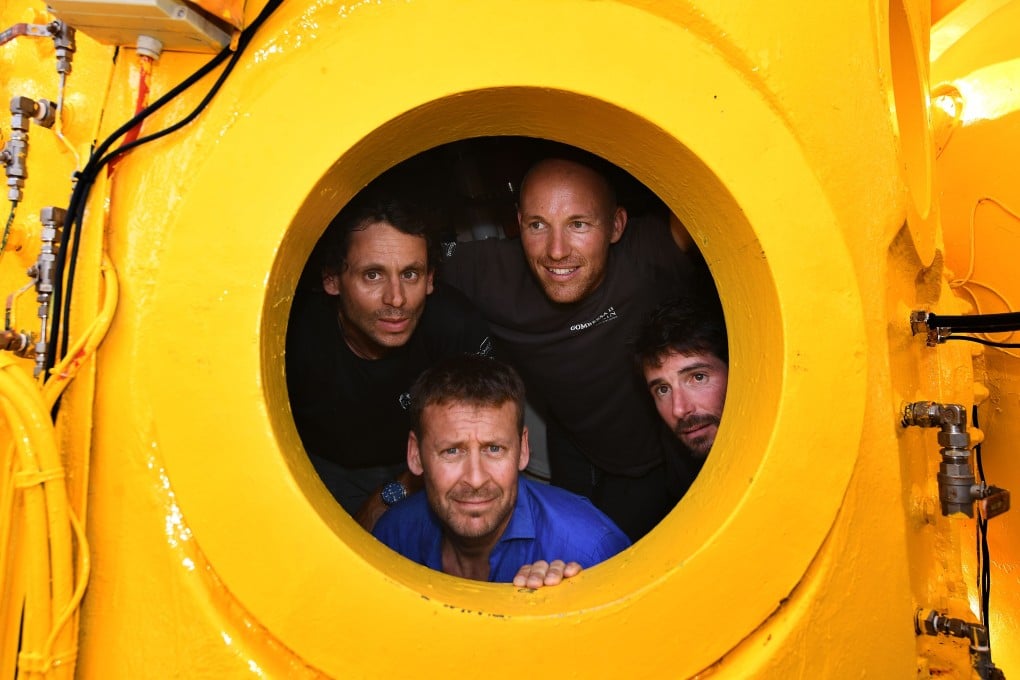 French biologist, marine naturalist and photographer, Laurent Ballesta (bottom poses inside his diving chamber with his crew in Marseille. Photo: AFP