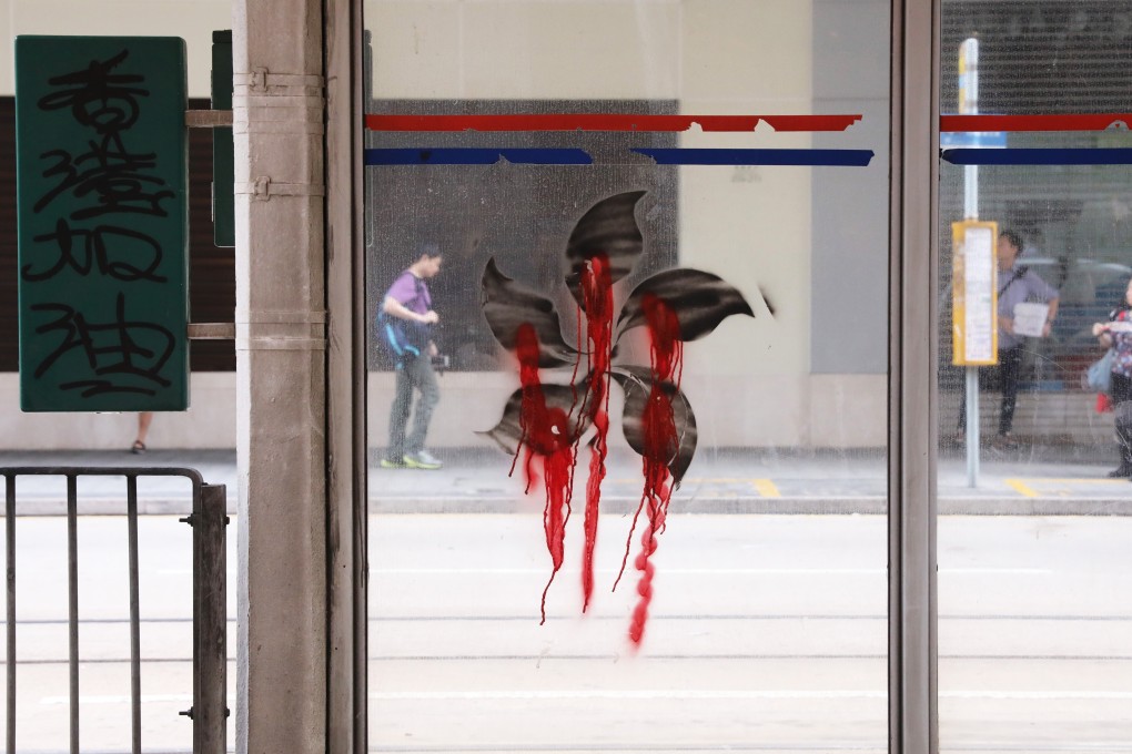 Protesters left a tram stop spray-painted with anti-government images after Sunday night’s clashes. Photo: K.Y. Cheng