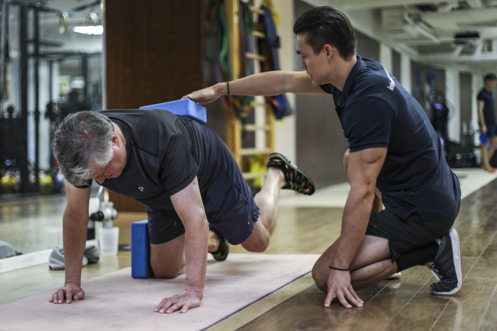 Exercises to help prevent falls: exercise physiologist Geoffrey Bland (right) leading his client Nick Colfer, 59, through a series of exercises at Joint Dynamics in Hong Kong’s Central district. Photo: Tory Ho