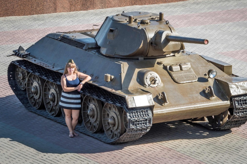 Russia has ambitious plans to become one of the world’s top 10 travel destinations. Here a woman poses next to a tank at the Volgograd Panorama Museum. Photo: AFP
