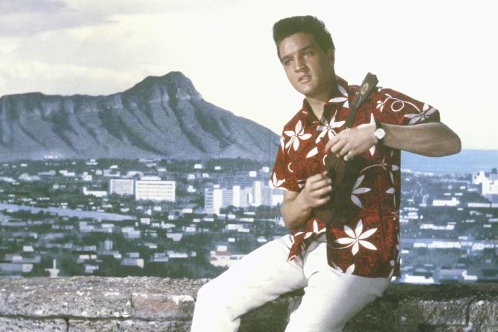 Elvis Presley wearing a Hawaiian shirt in the 1961 film Blue Hawaii, one of many actors to have sported the garment on screen. Chinese-American Ellery J. Chun was the first person in Hawaii to mass-produce the shirts after registering the trade name Aloha shirt. Photo: Alamy