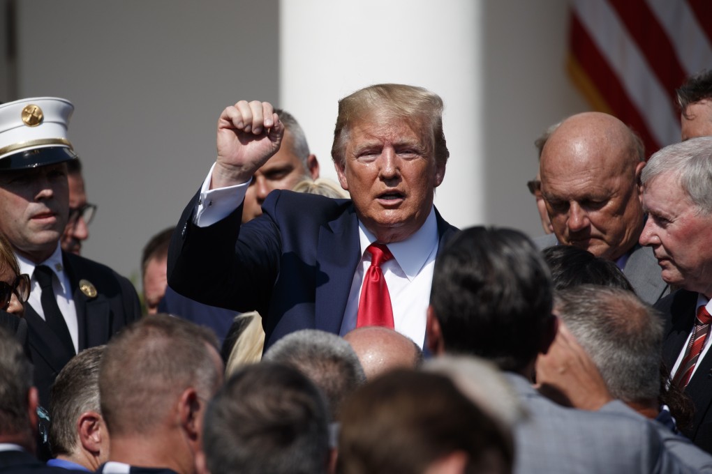 US President Donald Trump, with 9/11 first responders and family members, at the signing ceremony for a bill to permanently authorise the September 11 victim compensation fund in the Rose Garden of the White House on Monday. Photo: EPA-EFE