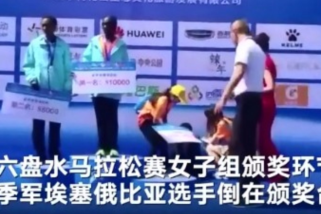 Alemaz Negede collapses on stage but the prize giving continues.