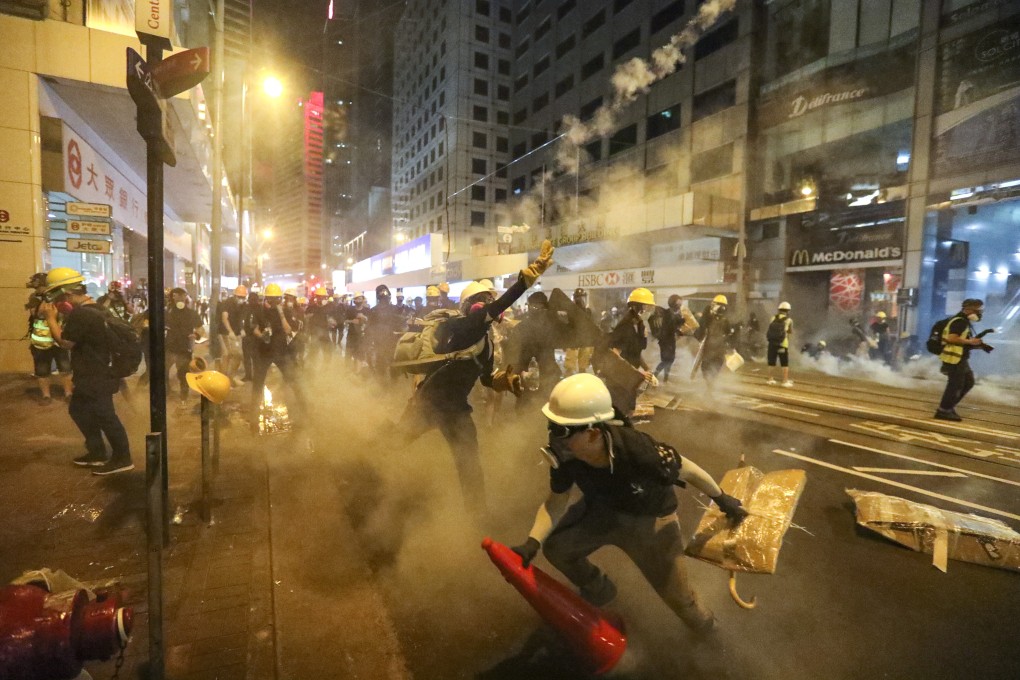 Riot police fired tear gas at anti-extradition bill protesters as they marched towards the central government’s liaison office on Sunday. Photo: Felix Wong