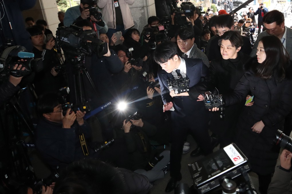 Seungri, a member of K-pop boy band Big Bang, is surrounded by reporters as he enters the Metropolitan Police Agency in Seoul in March, for questioning on suspicions that he solicited sexual favours for his business partners. Photo: EPA-EFE