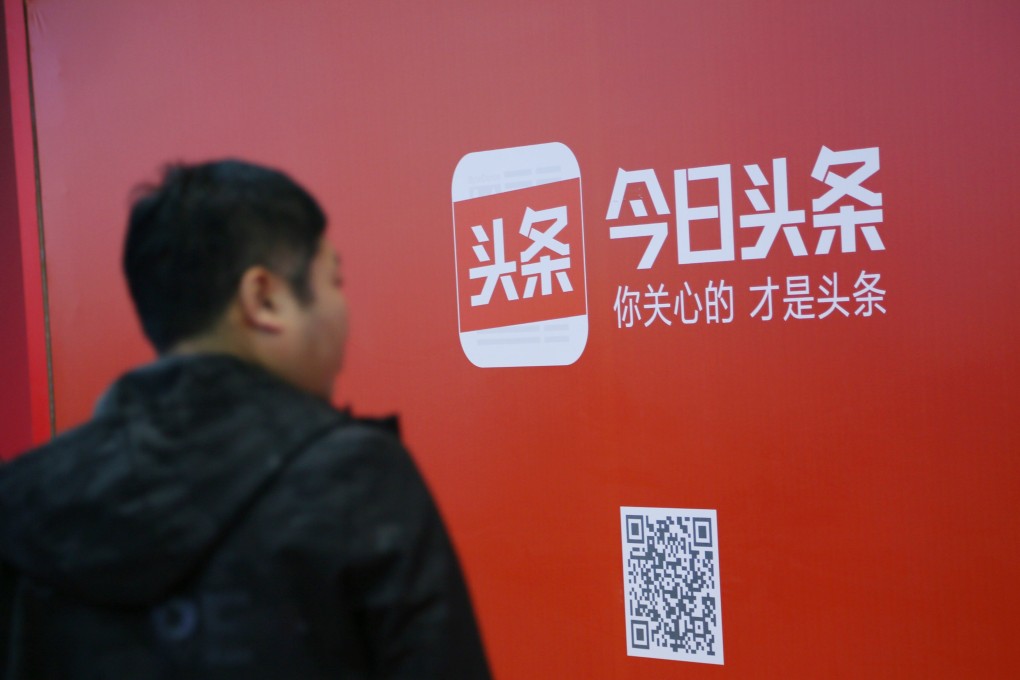 A man walks past an advertisement of Jinri Toutiao, the popular news aggregation app operated by Beijing-based ByteDance. Photo: Reuters