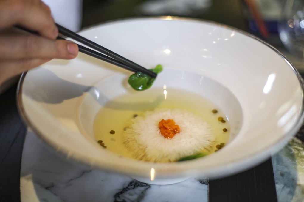 Chef Junno Li puts the finishing touches to a a serving of chrysanthemum “thousand cut” silken tofu in chicken broth at The Chinese Library in Central, Hong Kong. Photo: Tory Ho