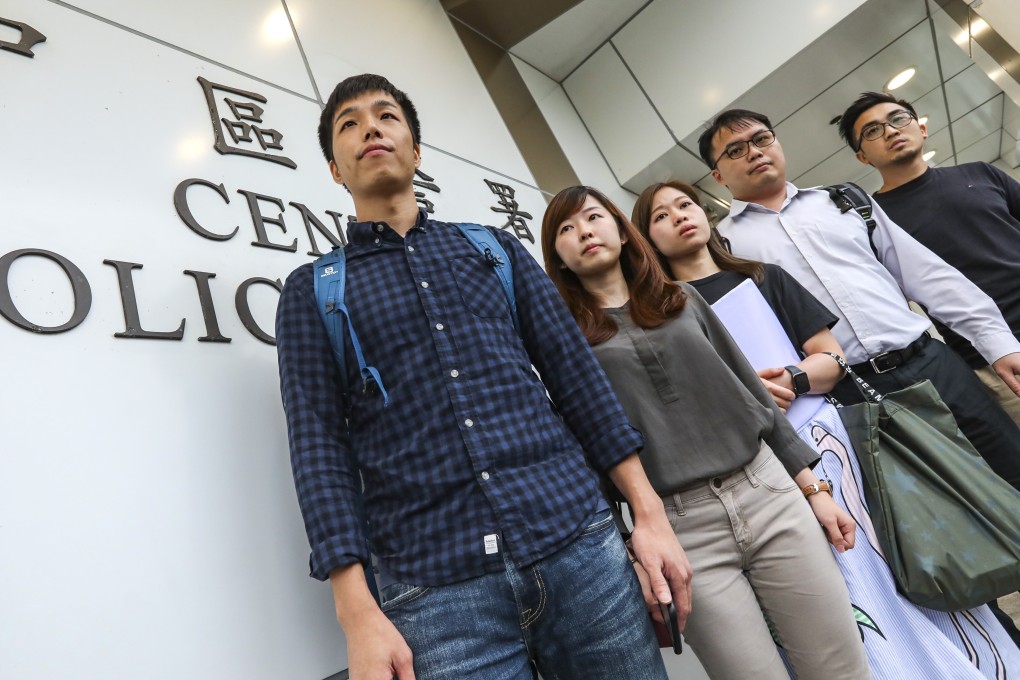 Michael Ngan (left) and fellow civil servants on Monday file an application to hold a rally at Central Police Station. Photo: Felix Wong