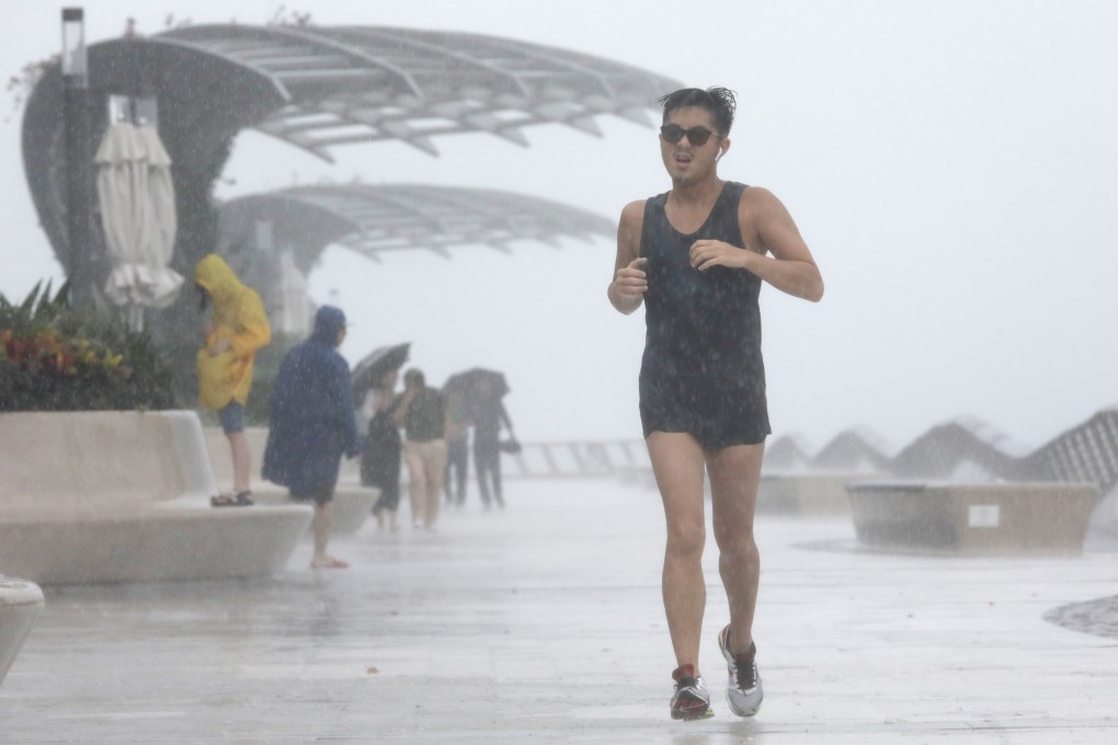 A man runs along Tsim Sha Tsui waterfront as Tropical Storm Wipha approaches Hong Kong. Photo: May Tse