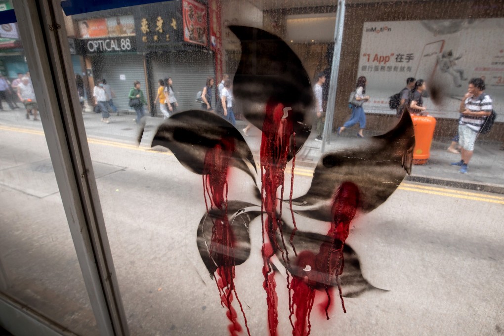 A black stencil of Hong Kong’s emblem, the bauhinia, is on a wall the morning after clashes between the police and protesters in Sheung Wan. Photo: Bloomberg
