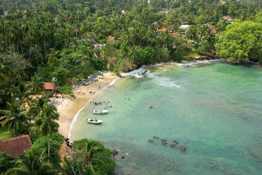 The beach at Dondra on the southern tip of Sri Lanka. Emerald vegetation, azure waters, and white sands define the beaches in the area. Photo: Alamy