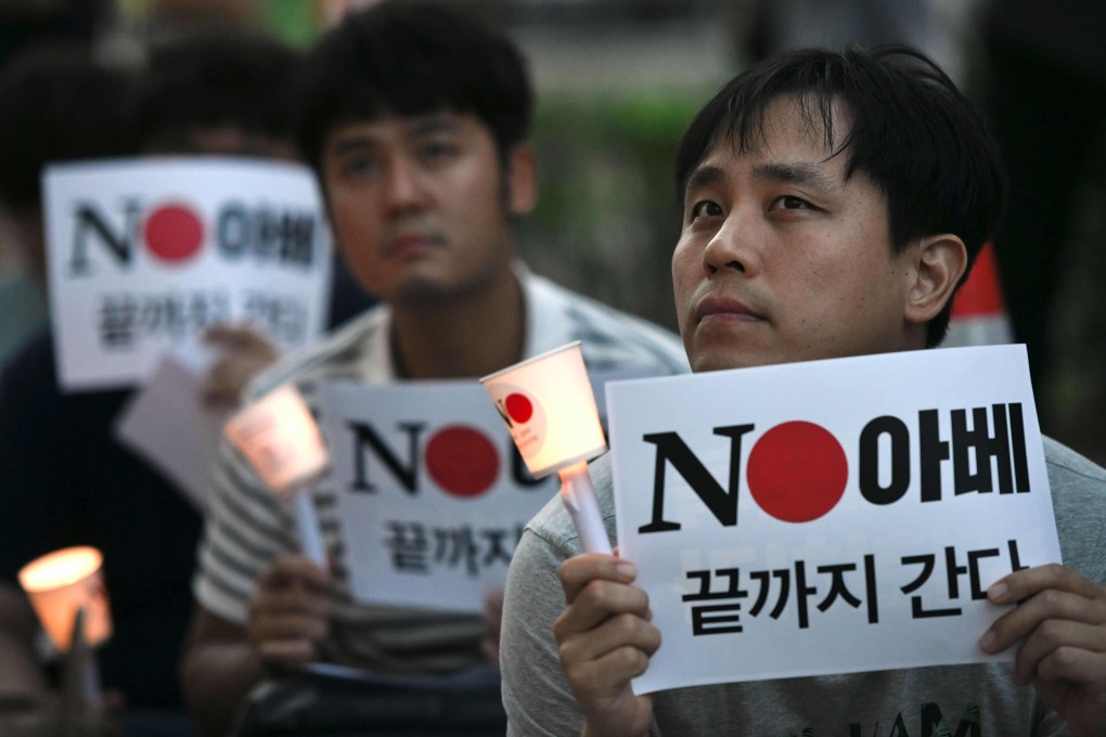 South Korean protesters hold signs reading "No Abe" during a candlelight rally denouncing Japan for its recent trade restrictions against Seoul on Thursday, August 1. Photo: AFP