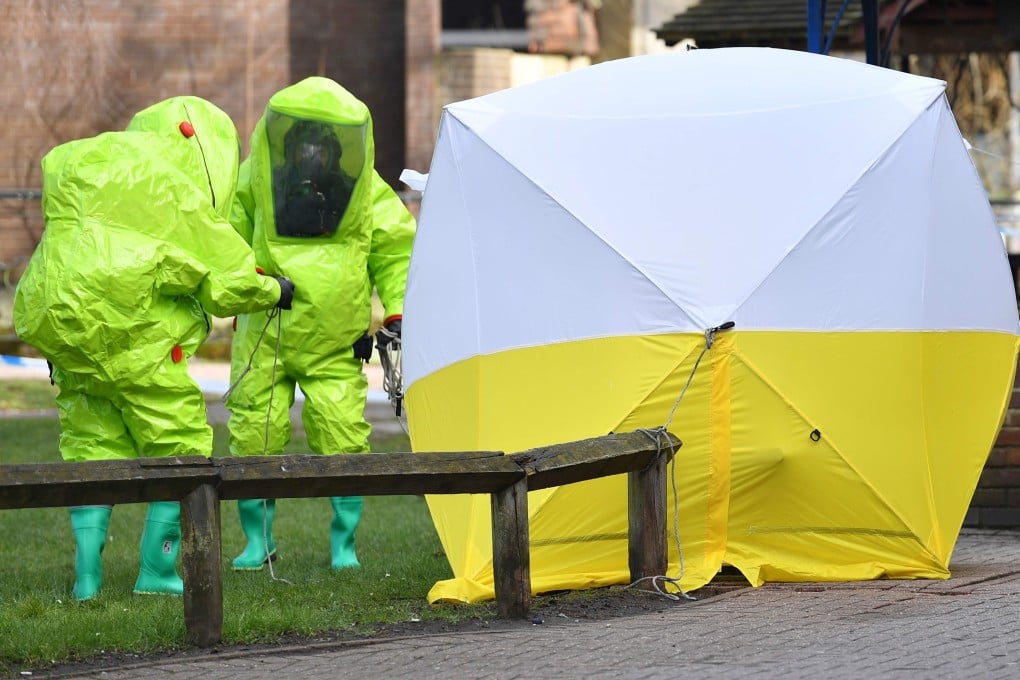 Members of the emergency services inspect the scene of the poisoning. Photo: AFP