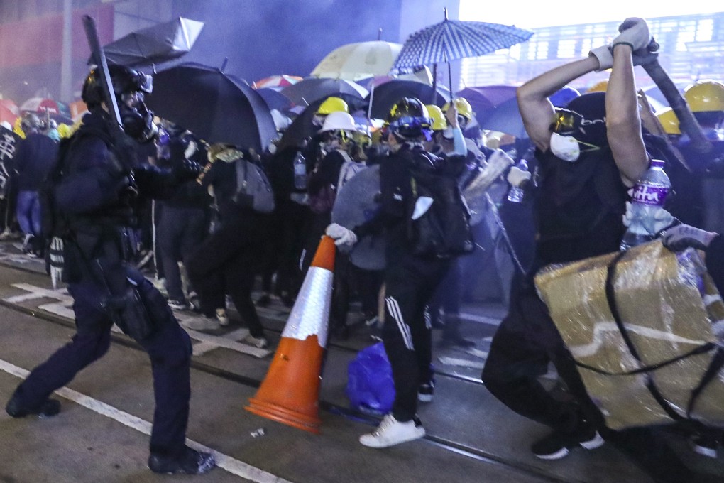 Extradition bill protesters clash with police on Des Voeux Road Central, as the law enforcers prevent them from proceeding towards the central government’s liaison office in Sai Ying Pun, on July 28. Photo: Sam Tsang